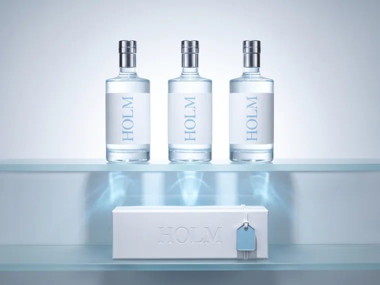 HOLM spirits — bottle range under backlight beside a debossed gift box